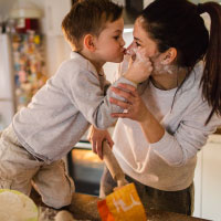 A mom and her son bonding in the kitchen.